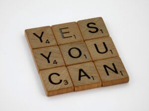 Scrabble tiles spelling motivational phrase