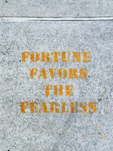 Text on concrete: Fortune favors fearless.