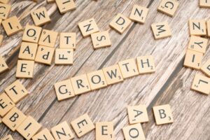 Scrabble tiles spelling 'GROWTH'