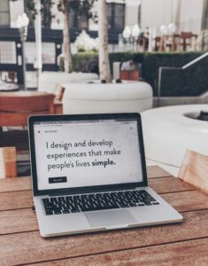 Laptop displaying design philosophy statement, beginner freelance portfolio example.