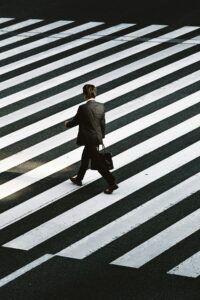 Businessman crossing a striped crosswalk, beginner freelance profile and portfolio example.